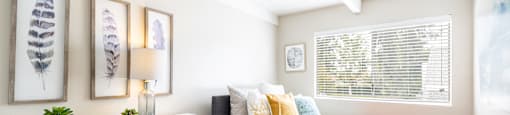 a bedroom with a bed and a dresser with a lamp on it