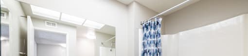 a bathroom with a sink and a bathtub with a shower curtain