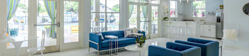 a living room filled with furniture and a large chandelier at Fusion Apartments, Orlando, FL 32818