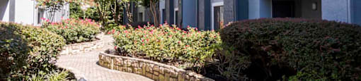 a brick path leading to an apartment building