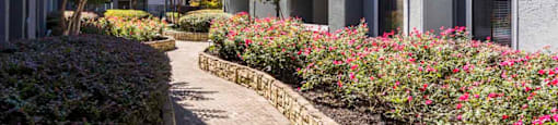 a brick walkway leading to an apartment building