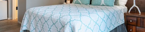 A bedroom with a bed and a wooden accent wall at Westmount at Urban Trails, Mesa