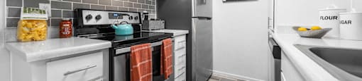 a kitchen with stainless steel appliances and white cabinets