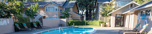 a hot tub in a pool in front of a house