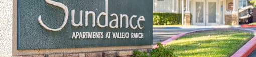 a stone monument sign for the sundance apartments at villas at valley blvd