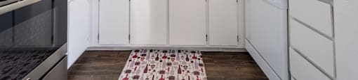 a kitchen with white cabinets and a sink