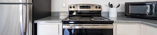 a kitchen with stainless steel appliances and white cabinets