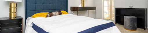 a bedroom with a bed and two night stands
