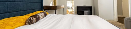 a bedroom with a large bed and a fireplace