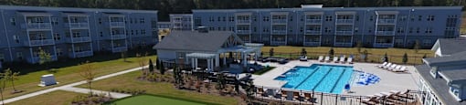 an aerial view of a resort with a pool and a golf course