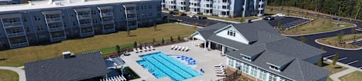 an aerial view of a resort with a swimming pool