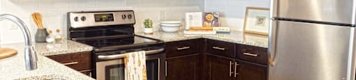a kitchen with stainless steel appliances and wooden cabinets