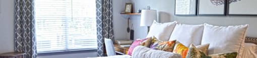 a bedroom with a bed and some pillows on it