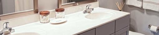 a bathroom with two sinks and a toilet and a mirror