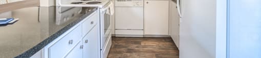 a kitchen with white appliances and white cabinets