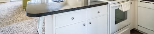 a kitchen with white appliances and a counter top