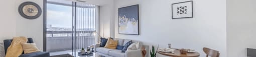a living room with a couch and a table with chairs