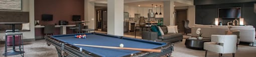 a clubhouse with a pool table in the middle