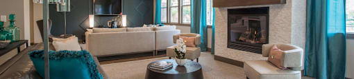 a living room with a fireplace and blue curtains