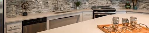 a kitchen with white cabinets and a white counter top