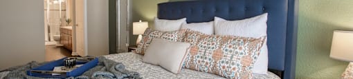 a bedroom with green walls and a bed with pillows