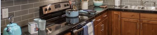 a kitchen with wooden cabinets and stainless steel appliances