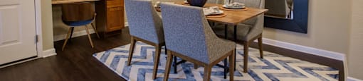 a dining room with a table and chairs