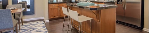 an open kitchen with stainless steel appliances and wooden cabinets
