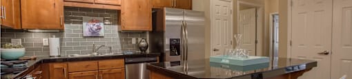 a kitchen with a counter top and a refrigerator