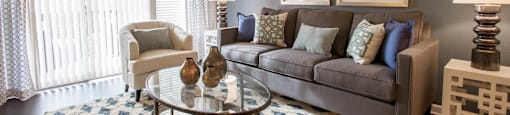 a living room with a couch and a glass table