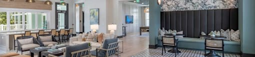 a lobby with couches chairs and tables and a large wall with a mural