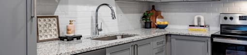 kitchen with white cabinets and granite counter tops and stainless steel appliances