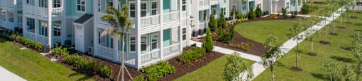 an aerial view of an apartment building with grass and trees