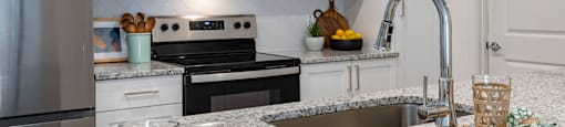 a kitchen with granite counter tops and stainless steel appliances