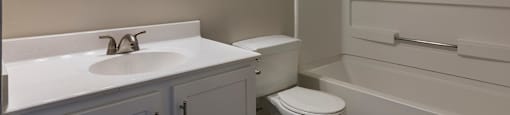 a bathroom with a sink toilet and a bath tub