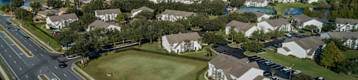 an aerial view of a neighborhood of houses and a highway