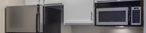 a kitchen with stainless steel appliances and white cabinets