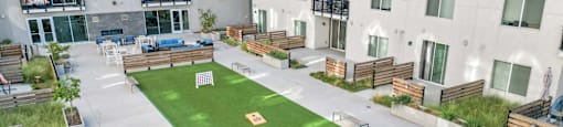 a yard with a lawn in the middle of an apartment building