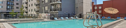 a swimming pool with a building in the background