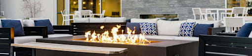 the outdoor patio of a building with a fire pit