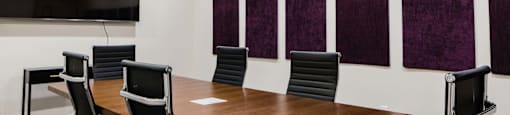 a conference room with a large table and chairs