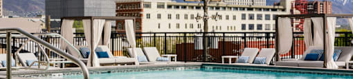 a swimming pool at a hotel with mountains in the background