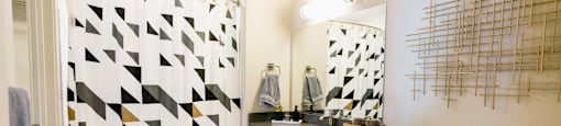 a bathroom with a shower and a sink and a toilet