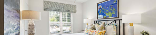 a bedroom with a bed and a ceiling fan