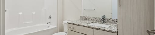 a bathroom with a sink and a toilet and a shower