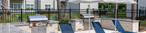 our apartments have a large patio with chairs and umbrellas