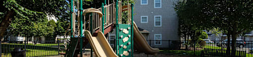 a playground with a jungle gym and slides