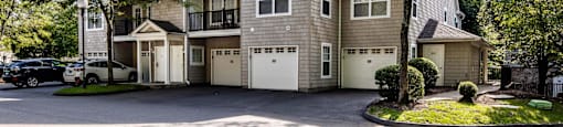 the front of a house with a driveway and a car garage