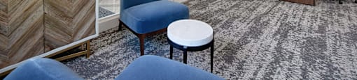 a living room with blue chairs and a table