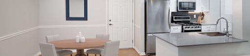 a kitchen and dining room with a table and chairs